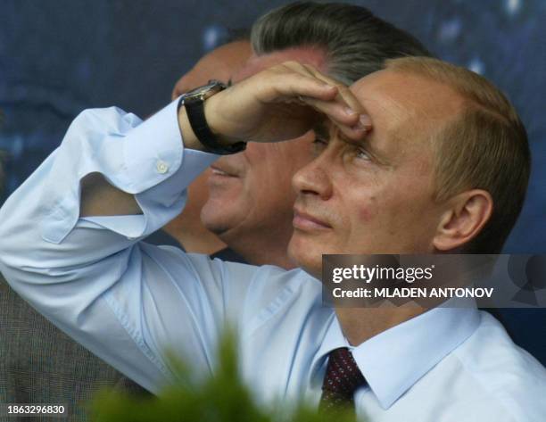 Russian President Vladimir Putin looks at the sky during the opening of the Sixth Moscow International Air Show at the airfield in Zhukovski, outside...