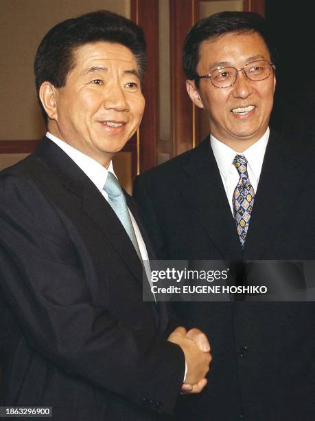 South Korean President Roh Moo-hyun and Shanghai's Mayor Han Zheng shake hands before a meeting in Shanghai 09 July, 2003. Roh appealed to Chinese...