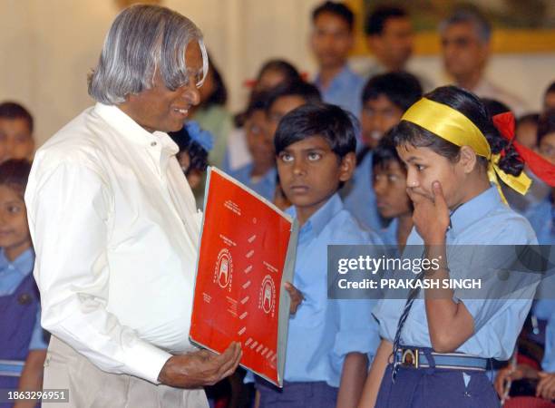 Indian President A. P. J. Abdul Kalam receives a card from underprivileged school children on the occasion of co-founder of the Indian constitution...