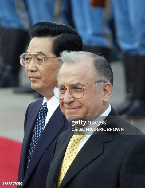 Visiting Romanian President Ion Iliescu walks beside Chinese President Hu Jintao during a welcoming ceremony at the Great Hall of the People in...
