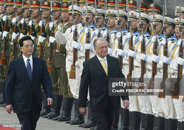 Visiting Romanian President Ion Iliescu walks with Chinese President Hu Jintao during a welcoming ceremony review of the honour guard, 20 August 2003...
