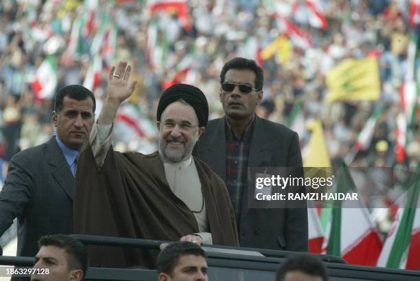 Iranian President Mohammad Khatami salutes a crowd of some 50,000 people 13 May 2003 before delivering a speech at Beirut's Sports City. Khatami...