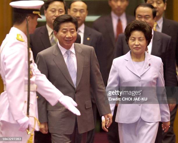 South Korean President Roh Moo-Hyun and his wife Kwon Yang-Sook are greeted by an honour guard upon their arrival at Seoul military airport in...