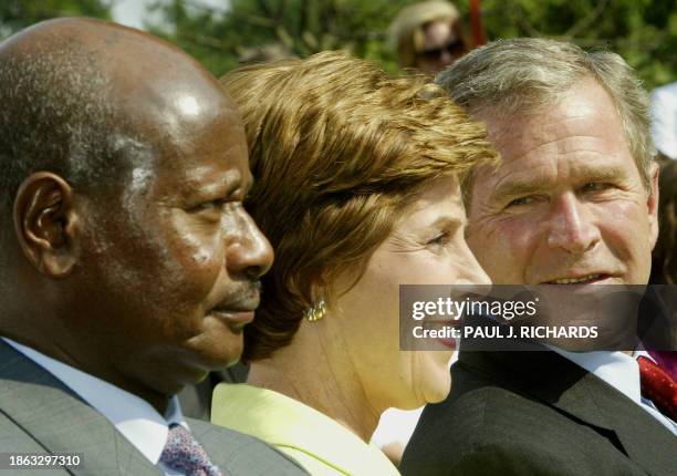 President George W. Bush , US First Lady Laura Bush , and the President of Uganda Yoweri Museveni applaud the performance by the Watoto Children's...