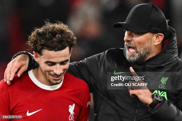 Liverpool's German manager Jurgen Klopp congratulates Liverpool's English midfielder Curtis Jones after winning at the end of the English League Cup...