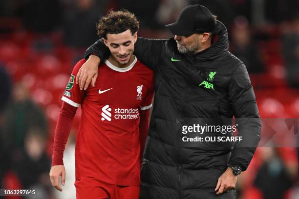 Liverpool's German manager Jurgen Klopp congratulates Liverpool's English midfielder Curtis Jones after winning at the end of the English League Cup...
