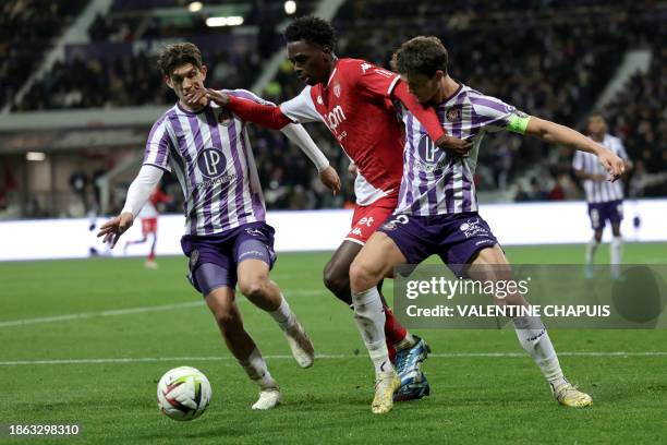 Monaco's French midfielder Soungoutou Magassa fights for the ball with Toulouse's Danish defender Rasmus Nicolaisen during the French L1 football...