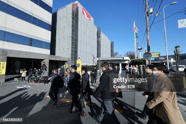 Officials from Japan's Ministry of Land, Infrastructure, Transport and Tourism enter the Daihatsu Motor headquarters for inspection work in Ikeda,...