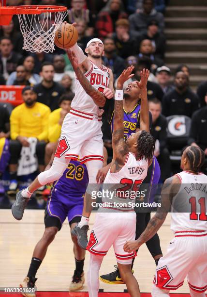 Alex Caruso of the Chicago Bulls blocks Cam Reddish of the Los Angeles Lakers layup during the first half against the Los Angeles Lakers at the...