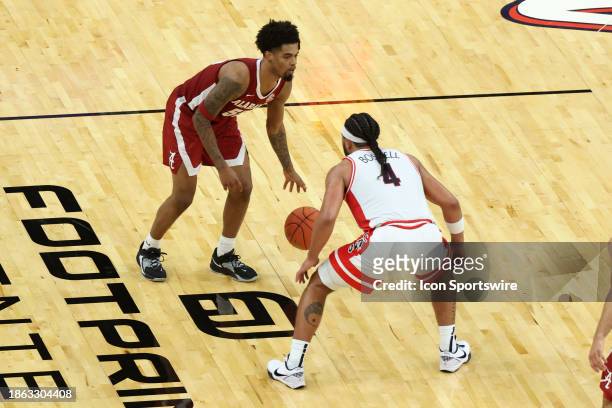 Alabama Crimson Tide guard Aaron Estrada dribbles the ball agaisnt Arizona Wildcats guard Kylan Boswell during the first half of a basketball game...