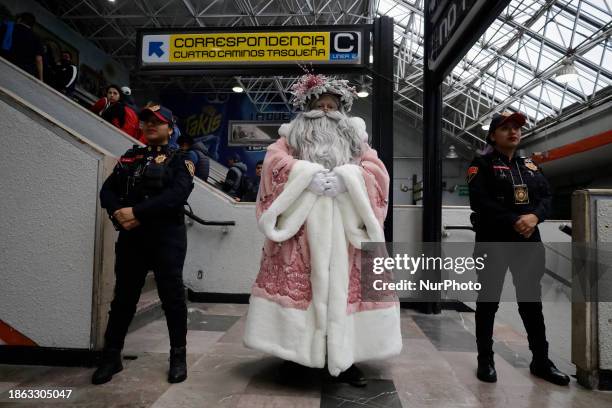 Jose Miguel Moctezuma Gonzalez, a street artist who specializes in human statues and makeup, is dressed as Father Christmas and is walking through...