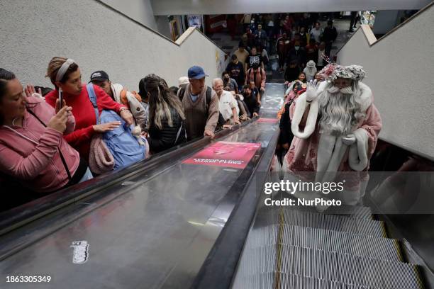 Jose Miguel Moctezuma Gonzalez, a street artist who specializes in human statues and make-up, is dressed as Father Christmas and is traveling around...