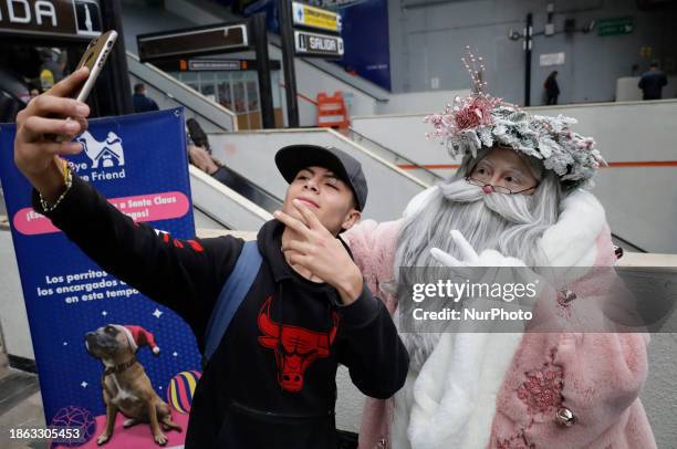 Jose Miguel Moctezuma Gonzalez, a street artist who specializes in human statues and make-up, is dressed as Father Christmas and is traveling around...