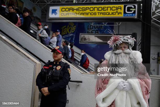 Jose Miguel Moctezuma Gonzalez, a street artist who specializes in human statues and makeup, is dressed as Father Christmas and is walking through...