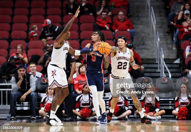 Tre White of the Louisville Cardinals knocks the ball away from Houston Mallette of the Pepperdine Waves in the second half at KFC YUM! Center on...