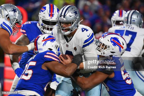 Tyrel Dodson and Greg Rousseau both of the Buffalo Bills sack Dak Prescott of the Dallas Cowboys during the third quarter at Highmark Stadium on...