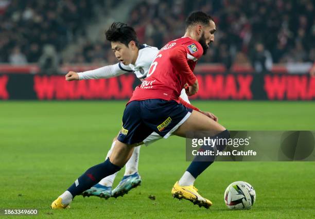 Nabil Bentaleb of Lille, Lee Kang-in of PSG in action during the Ligue 1 Uber Eats match between Lille OSC and Paris Saint-Germain at Stade...