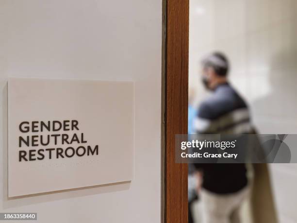 man waits in line in gender neutral restroom - bathroom stall door interior stock pictures, royalty-free photos & images