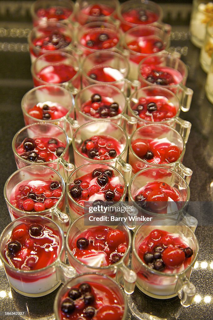 Rows of red and white breakfast glasses of yogurt