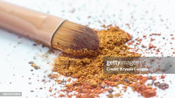 cosmetic brush on gold eyeshadow powder - blusher brush stock pictures, royalty-free photos & images