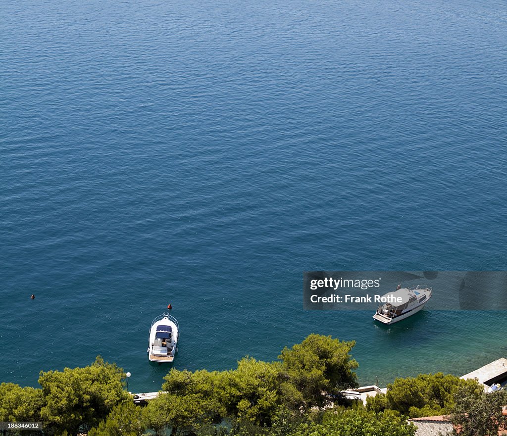 Two boats on the open blue mediterranean sea