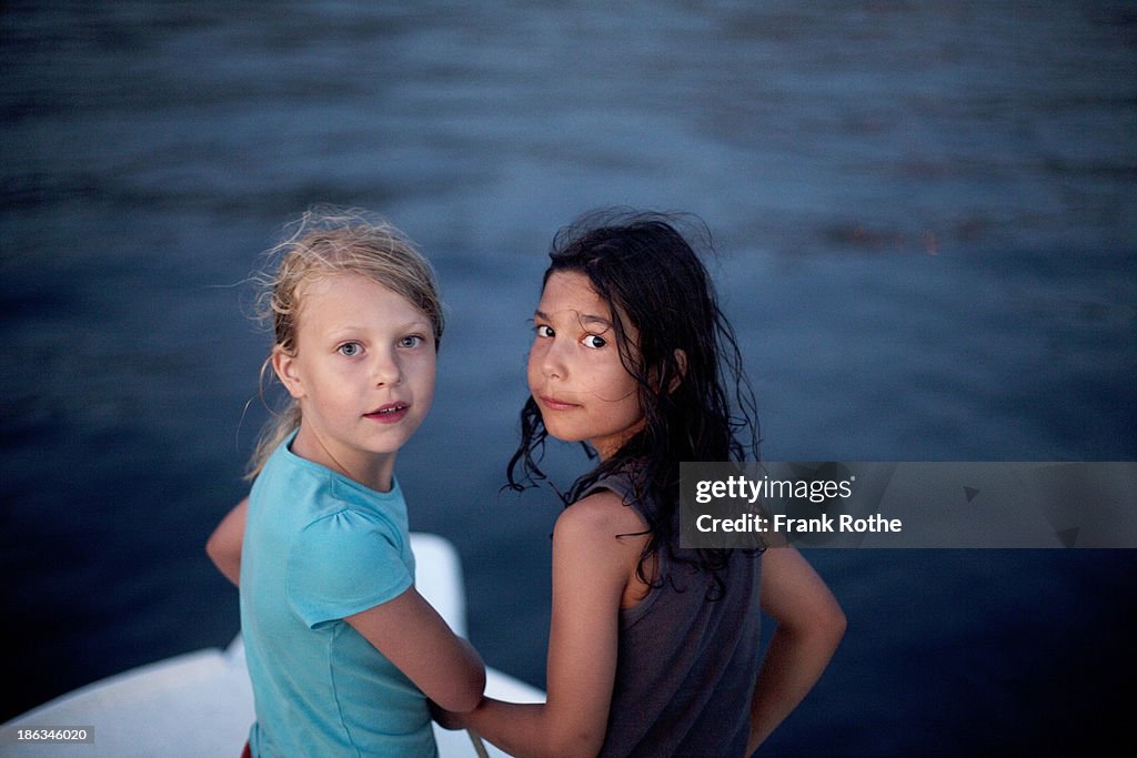 Two children in a boat on the sea