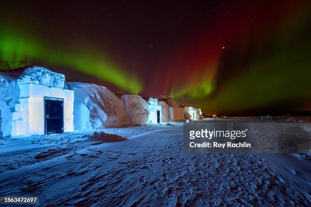 View of the backside of Icehotel 34 with the Northern Lights or Aurora Borealis over it on December 16, 2023 in Jukkasjarvi, Sweden. Since 1989, the...