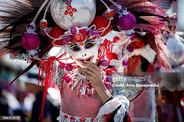 Masskara Festival performers wearing outstanding costumes and masks. MassKara Festival, one of the biggest and most colorful Filipino festivals, is...