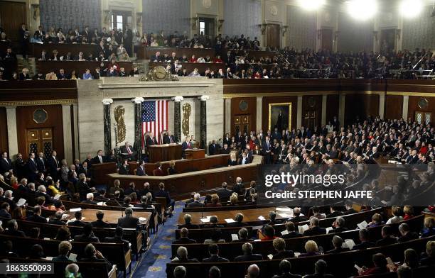 President George W. Bush acknowledges applause from members of Congress in the House of Representatives Chamber during his State of the Union address...