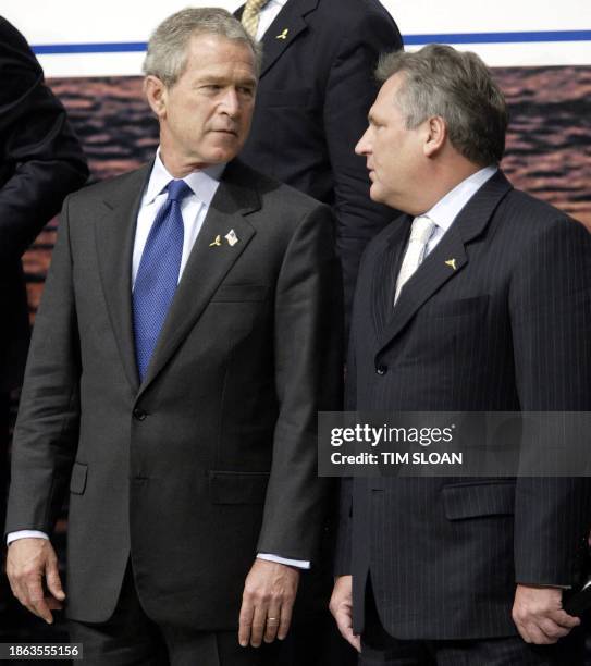 President George W. Bush talks with Polish President Aleksander Kwasniewski during the "class photo" after the opening session of the NATO Summit 28...