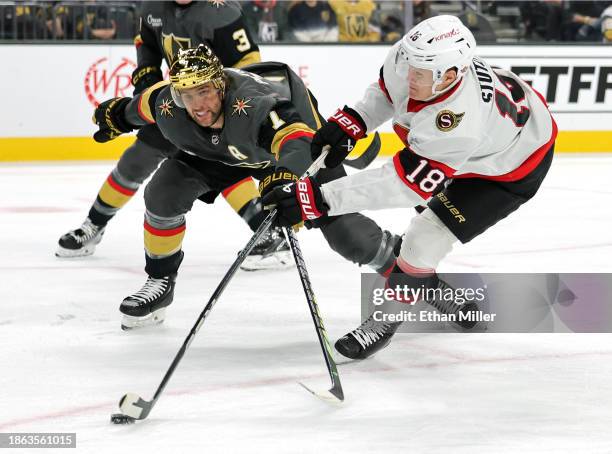 Tim Stutzle of the Ottawa Senators shoots against Alex Pietrangelo of the Vegas Golden Knights in the first period of their game at T-Mobile Arena on...