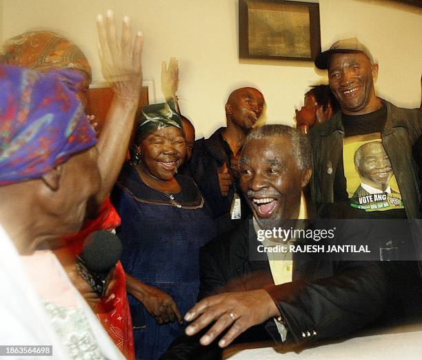 Thabo Mbeki, president of the African National Congress , South Africa's ruling party, jokes with an old lady and residents of Manelodi on his...