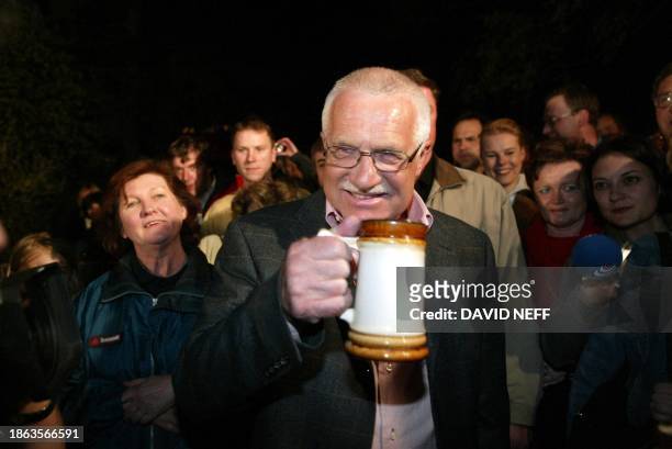 Czech President Vaclav Klaus toasts with fellow compatriots to celebrate their country's entry to the European Union 01 May 2004 at the top of Mont...