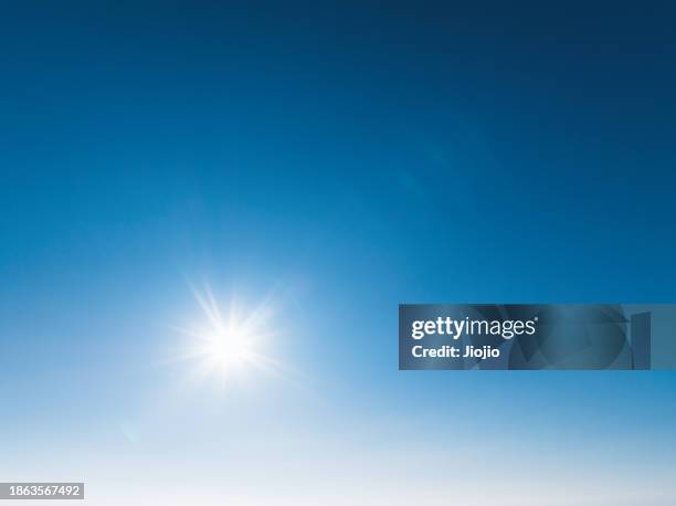 clear blue sky background with bright sun - toned image stock pictures, royalty-free photos & images