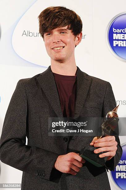 James Blake poses in front of the winners boards during the Barclaycard Mercury Prize 2013 at The Roundhouse on October 30, 2013 in London, England.