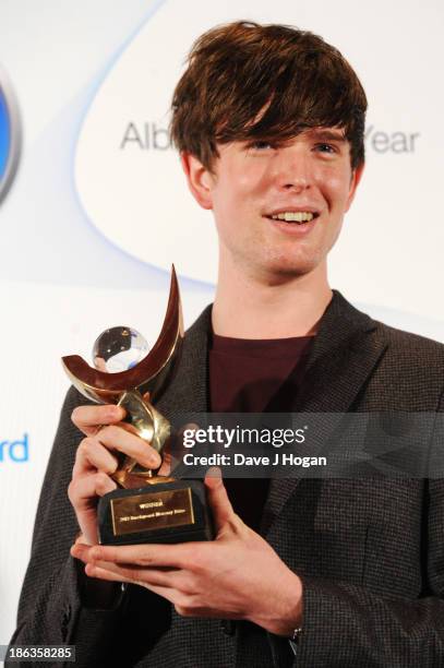 James Blake poses in front of the winners boards during the Barclaycard Mercury Prize 2013 at The Roundhouse on October 30, 2013 in London, England.