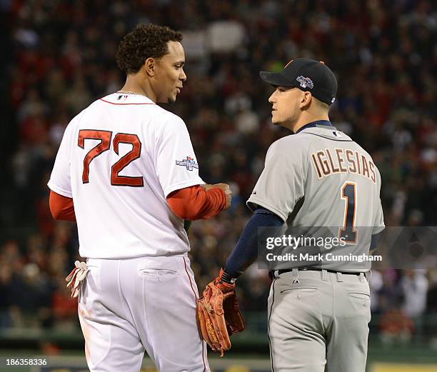 Xander Bogaerts of the Boston Red Sox and Jose Iglesias of the Detroit Tigers talk during Game Six of the American League Championship Series at...
