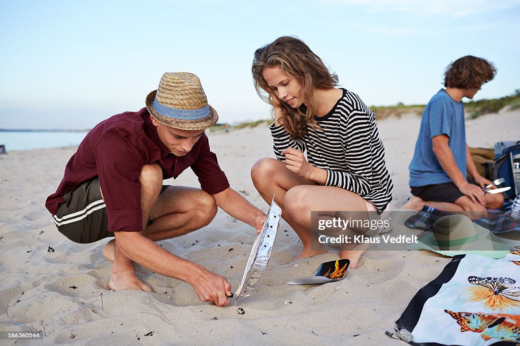 2 teens firing up grill