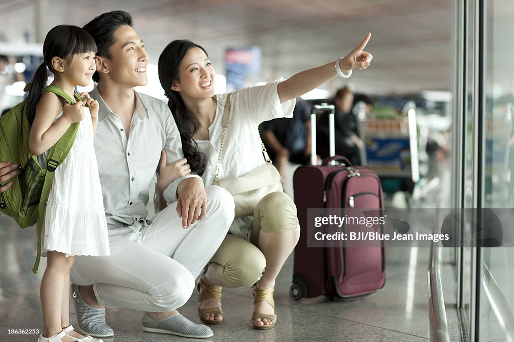 Young family looking at view at the airport