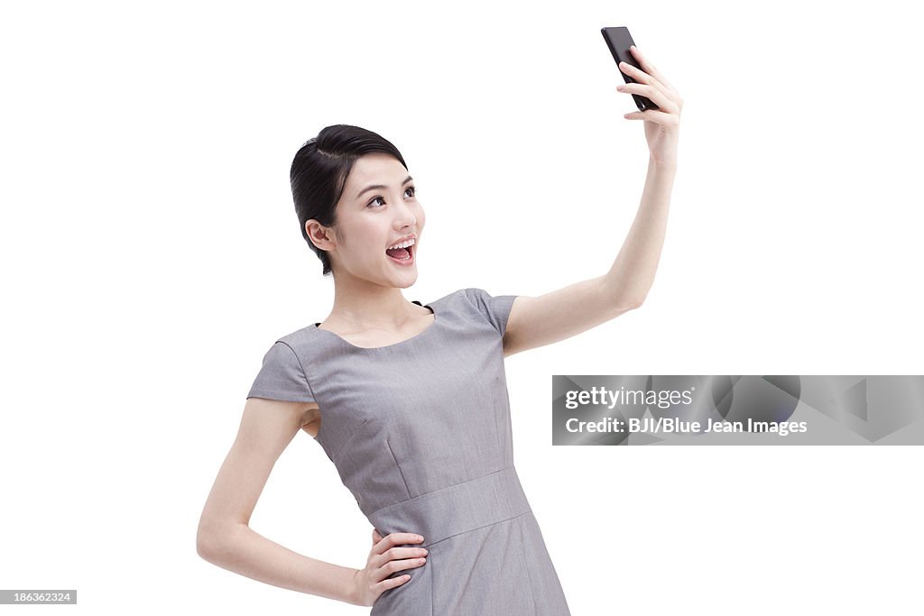 Young businesswoman photonic with mobile phone