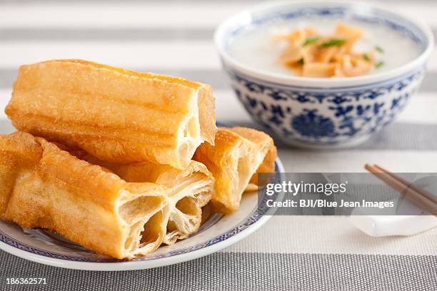 chinese food rice porridge and youtiao - youtiao stock pictures, royalty-free photos & images