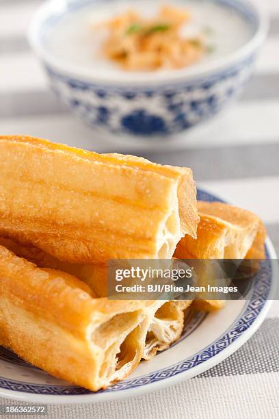 chinese food rice porridge and youtiao - youtiao stock pictures, royalty-free photos & images