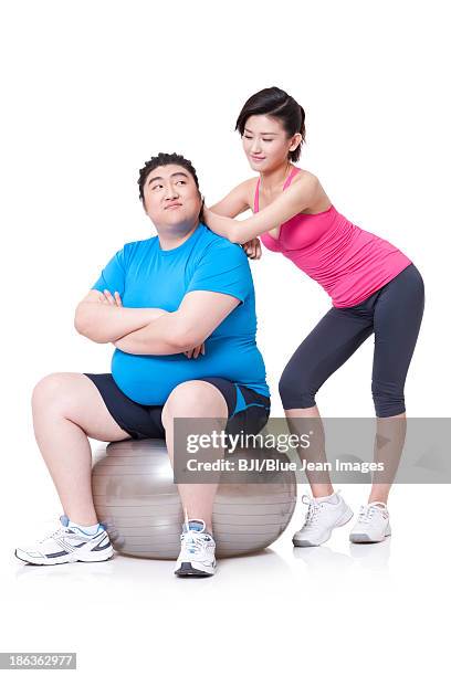 happy fat man and girlfriend with fitness ball - fat man sitting stock pictures, royalty-free photos & images
