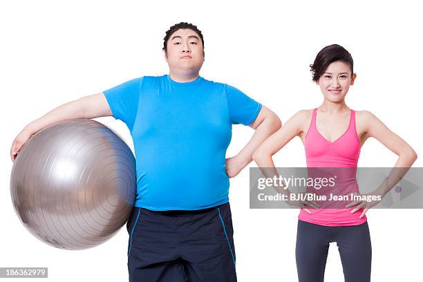 happy fat man and young woman with fitness ball - asian female bodybuilder stock-fotos und bilder