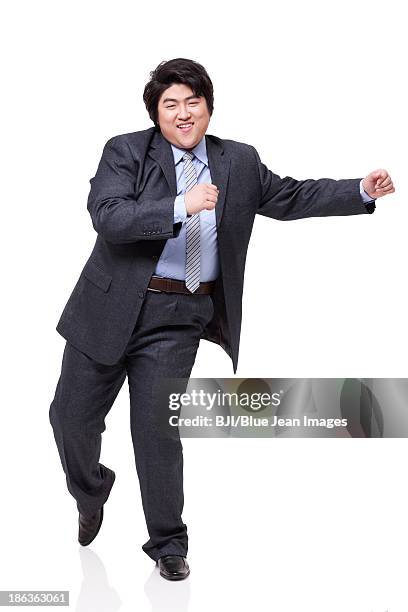 happy overweight businessman dancing - fat man in suit stock pictures, royalty-free photos & images