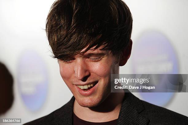 James Blake poses in front of the winners boards during the Barclaycard Mercury Prize 2013 at The Roundhouse on October 30, 2013 in London, England.