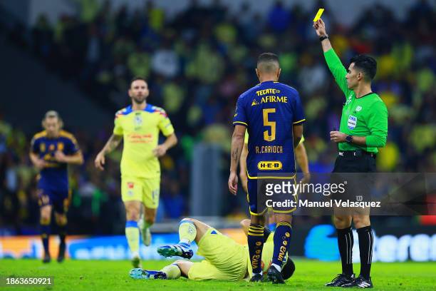 Referee Adonai Escobedo shows a yellow card during the final second leg match between America and Tigres UANL as part of the Torneo Apertura 2023...
