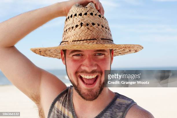 caucasian man smiling on beach - straw hat stock pictures, royalty-free photos & images