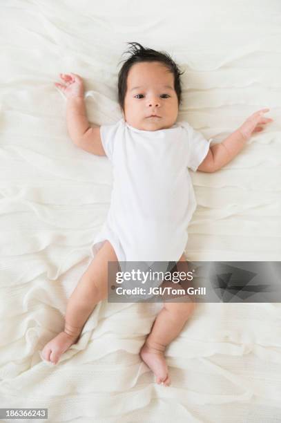 hispanic infant laying on blanket - sparkdräkt bildbanksfoton och bilder