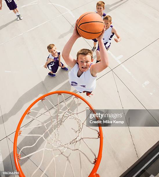 caucasian boys playing basketball on court - court notice bildbanksfoton och bilder